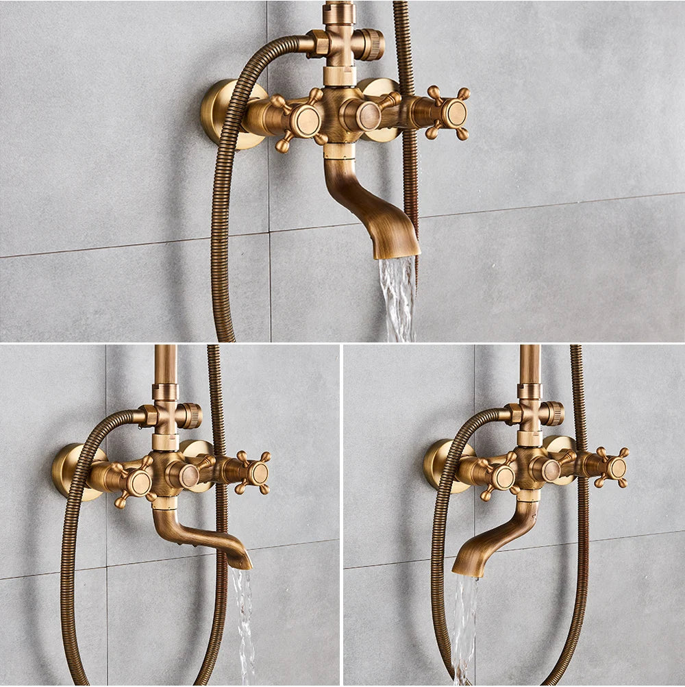 Antique brass cross-handle mixer and tub spout running water against a gray tiled wall