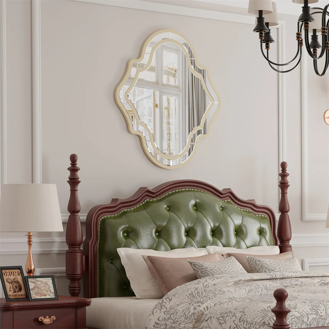 Quatrefoil wall mirror with a slim gold rim in a living room