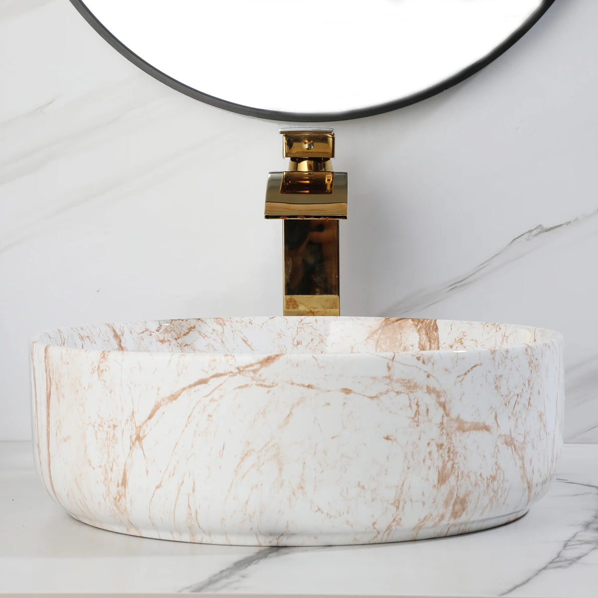 White marble-look ceramic vessel sink with tall gold faucet, side view