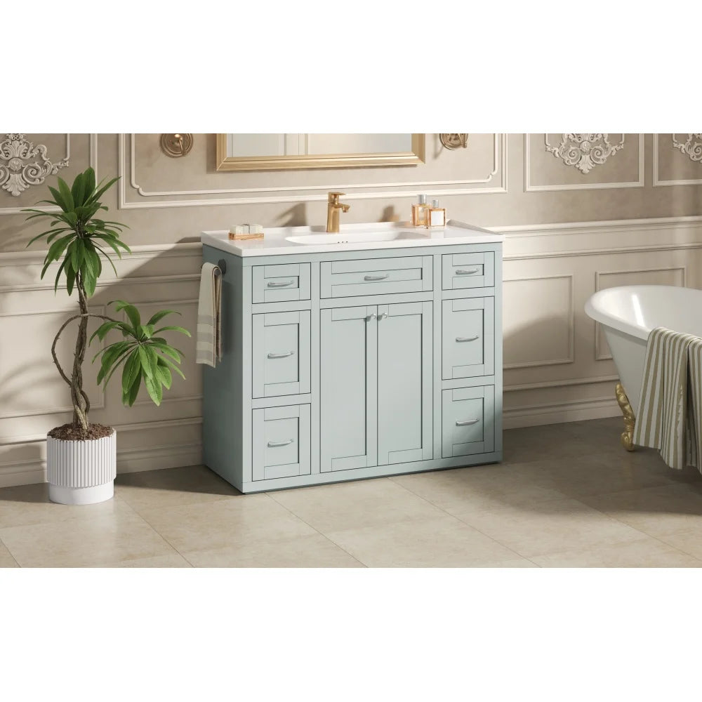 Mint green vanity styled in a bathroom with a clawfoot tub
