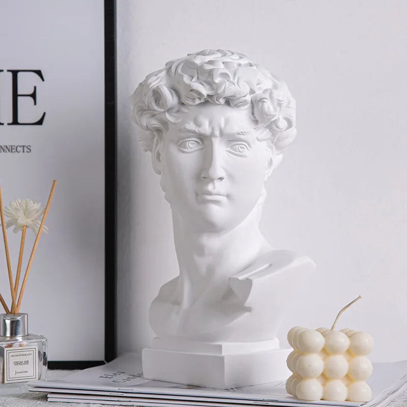 White classical David bust with a gold eye band, styled on a shelf