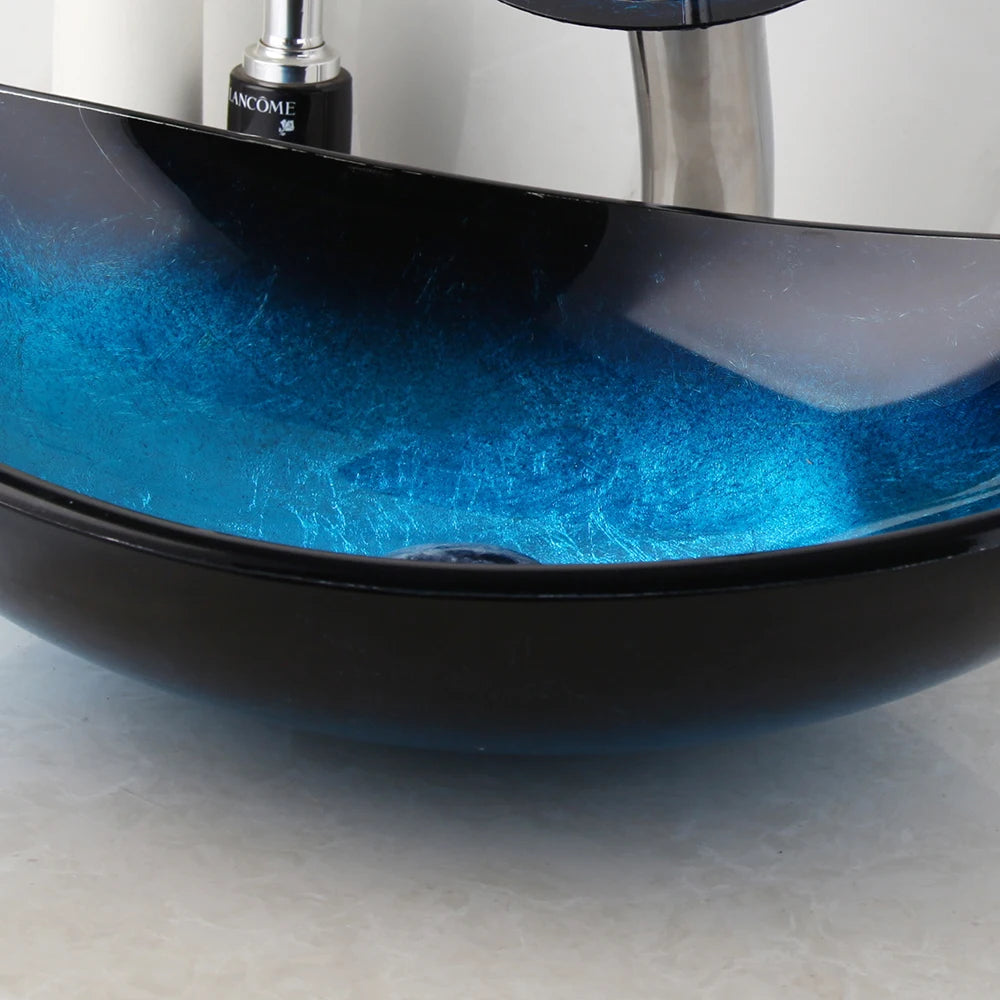 Blue gradient tempered glass oval vessel sink, side view of the deep blue to black edge