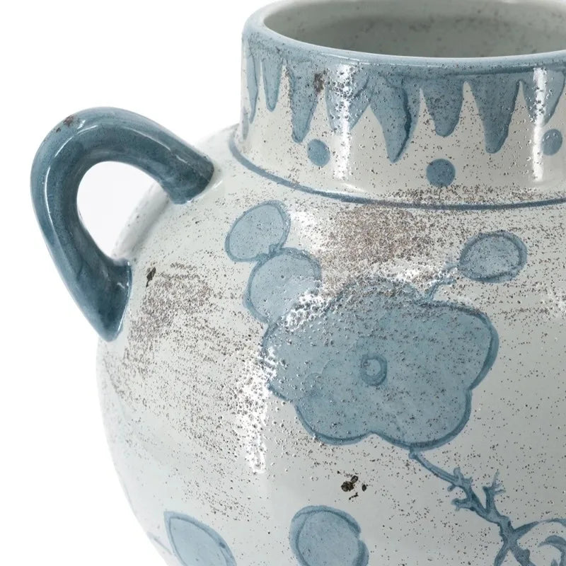Close view of the hand-painted blue botanicals and crackled glaze