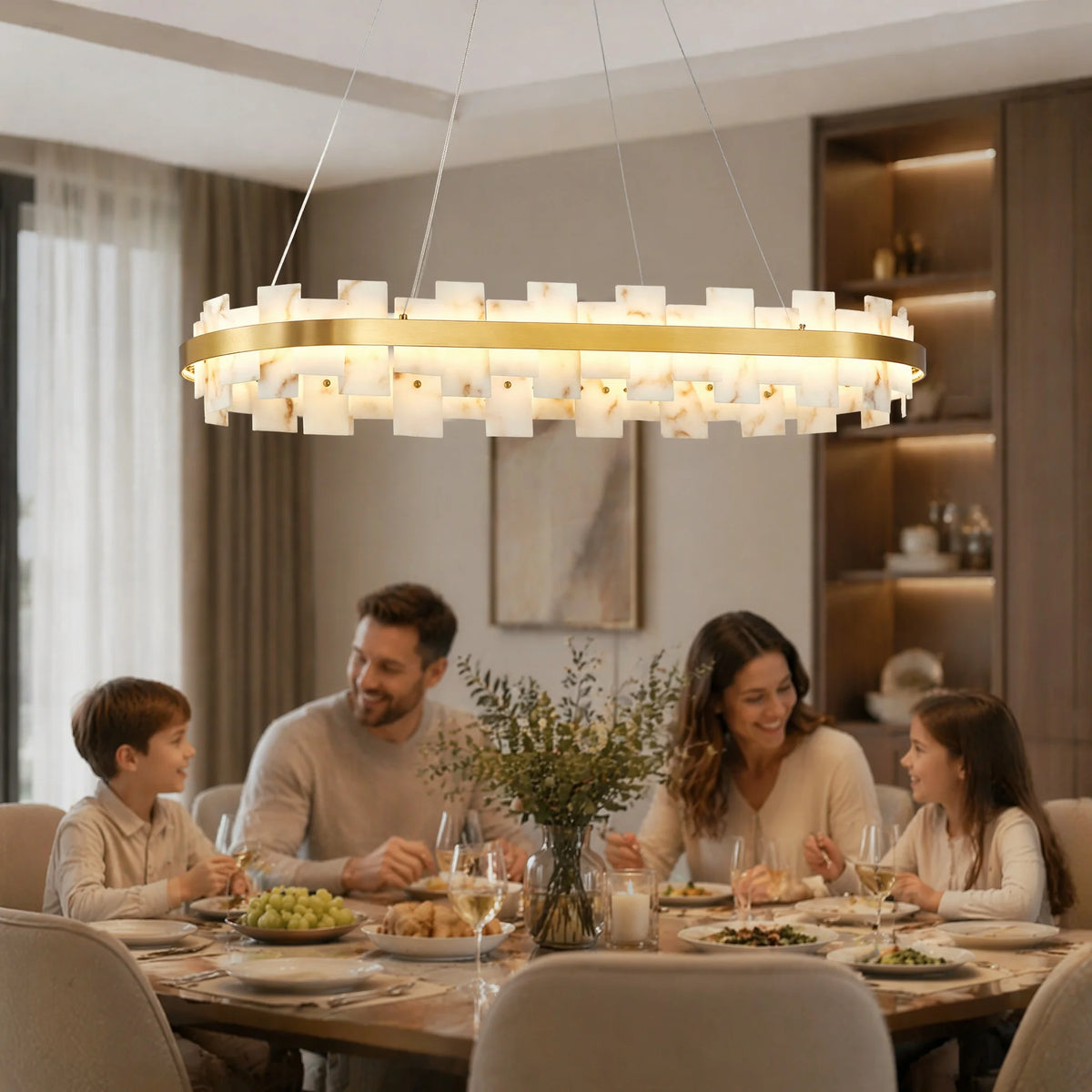 Oval alabaster linear chandelier glowing above a family dining table