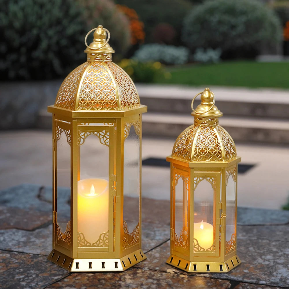 Set of two gold Moroccan candle lanterns with filigree domes and glass panels (on a patio)