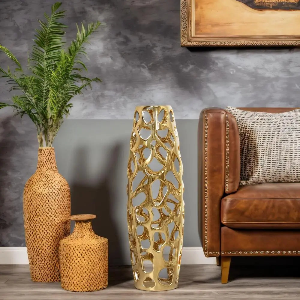 Gold coral-lattice floor vase beside a leather sofa