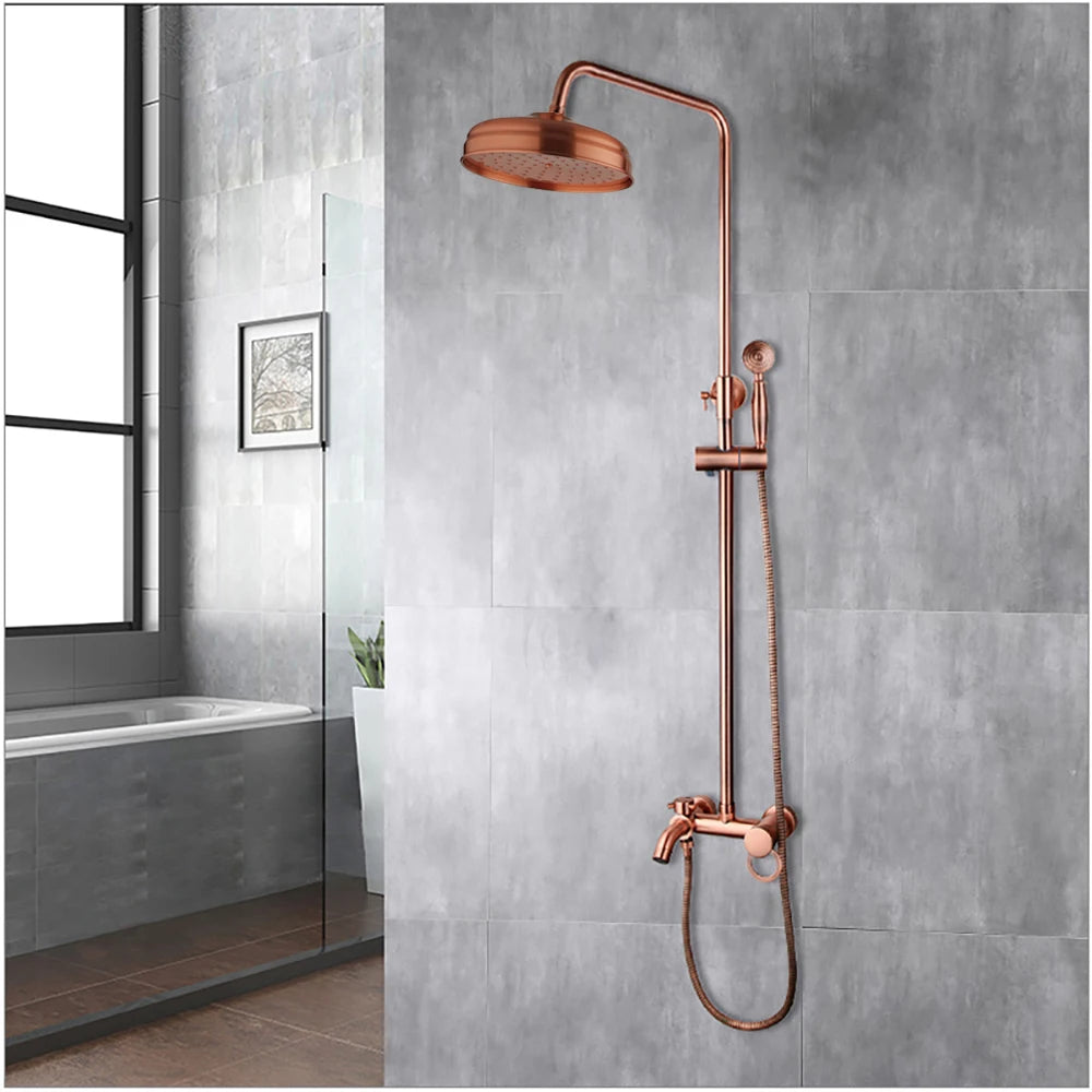 Antique copper exposed rainfall shower set mounted on a gray tile wall beside a bathtub
