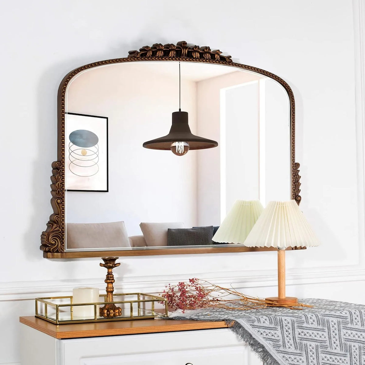 Antique gold baroque mirror with carved crest styled with a pleated lamp and tray