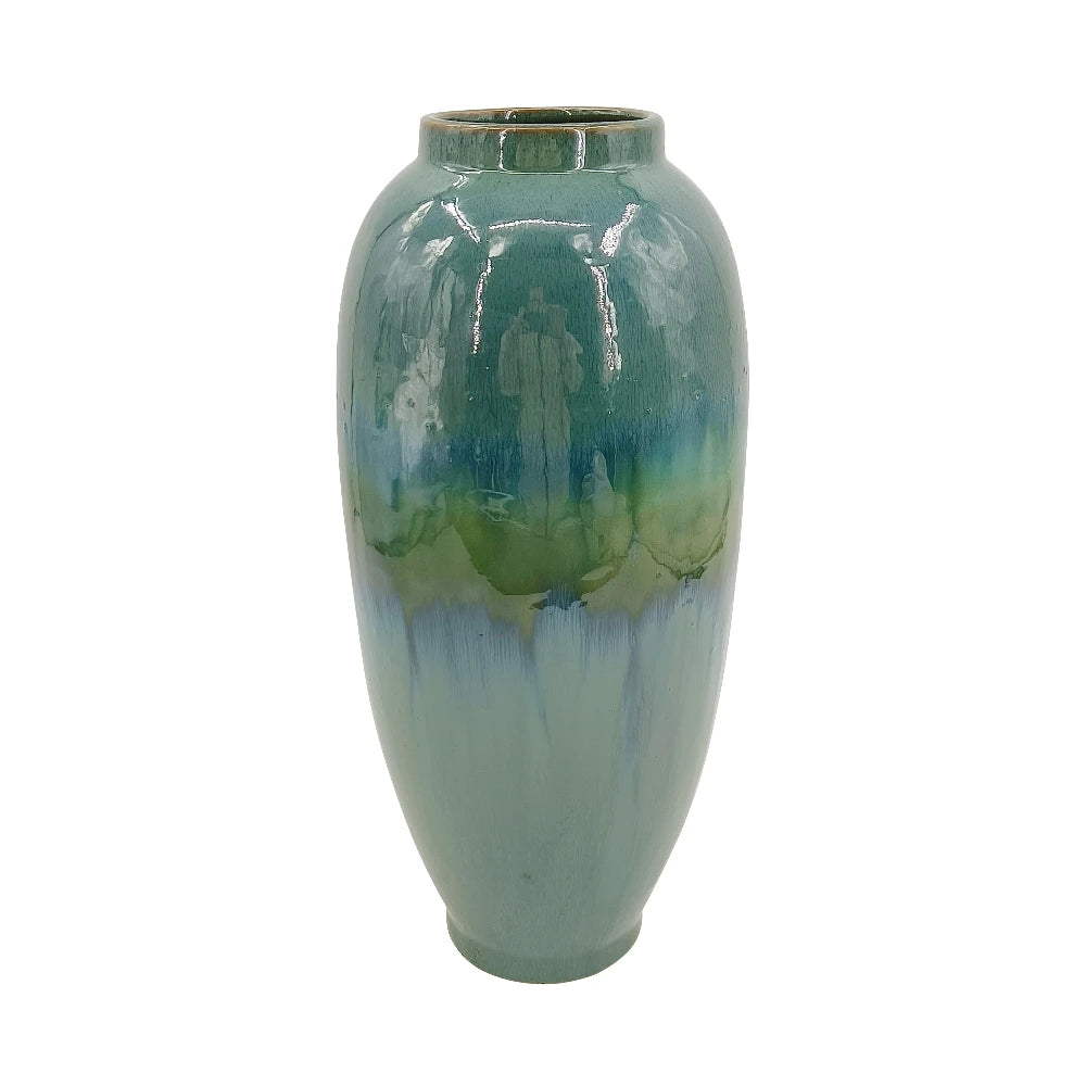 Tall teal reactive-glaze ceramic vase on a white background