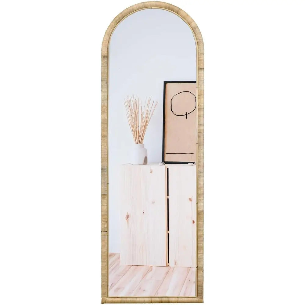 Rattan arched full-length mirror, 64 x 20 in, leaning against a wall
