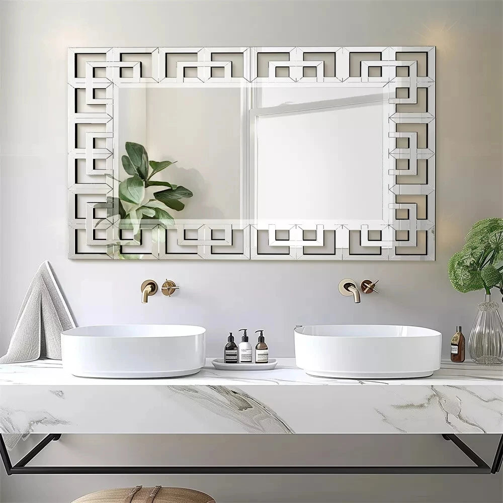 Greek-key Venetian mirror above a white marble double vanity with vessel sinks