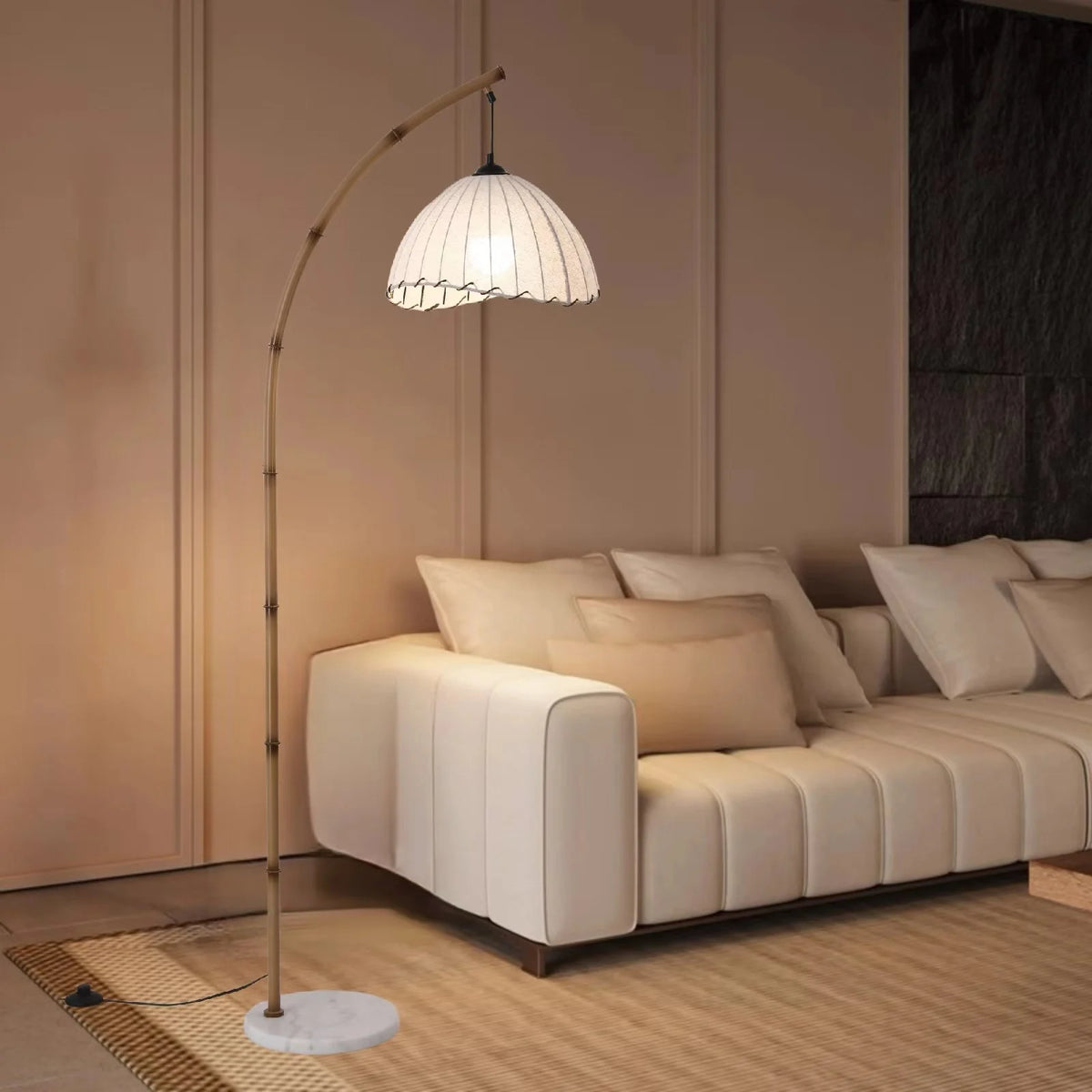 Bamboo arc floor lamp arching over a white sofa