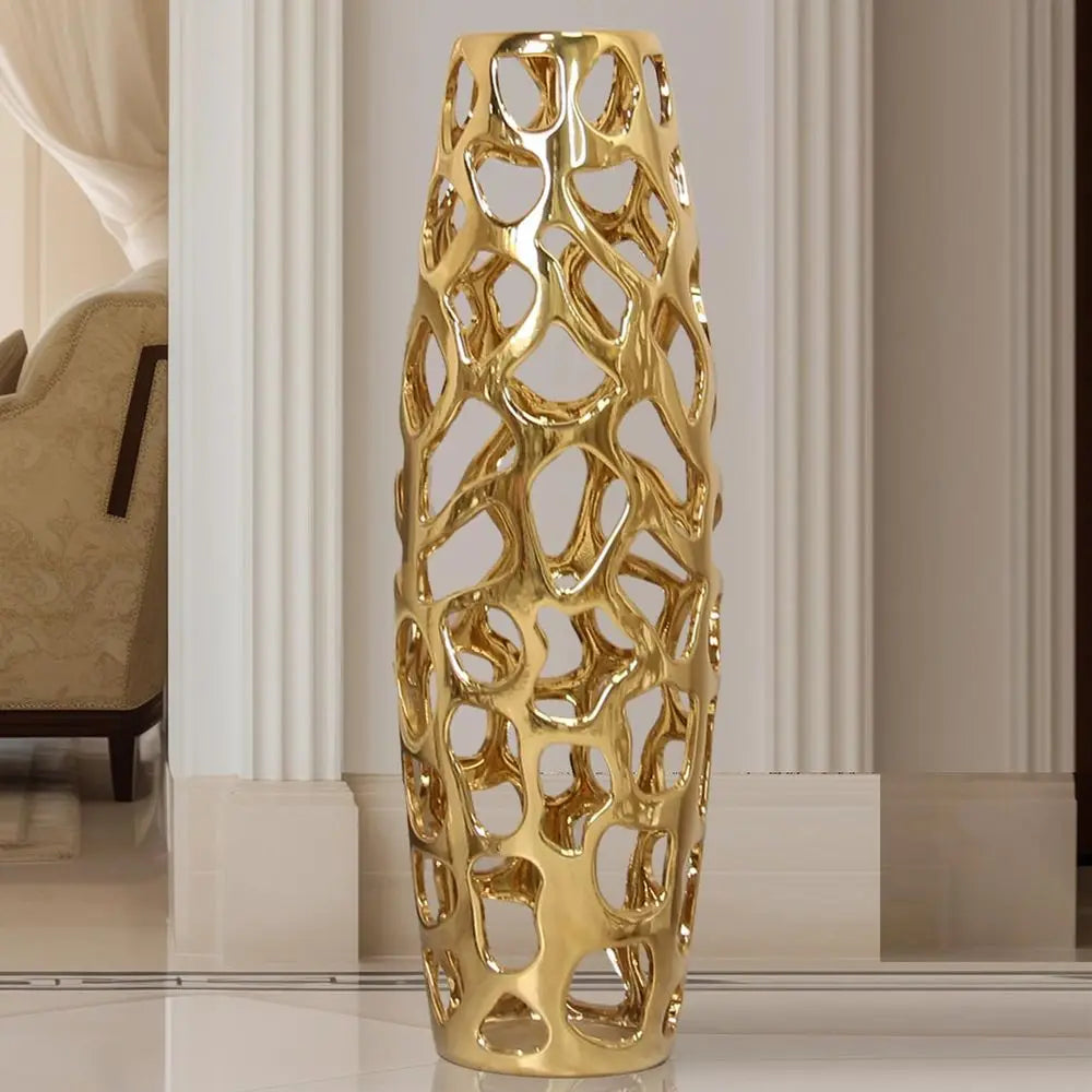 Gold openwork ceramic floor vase, 24 in, in a white entry