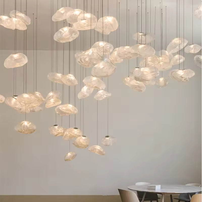 Many amber-toned cloud glass pendant lights suspended above a cafe table