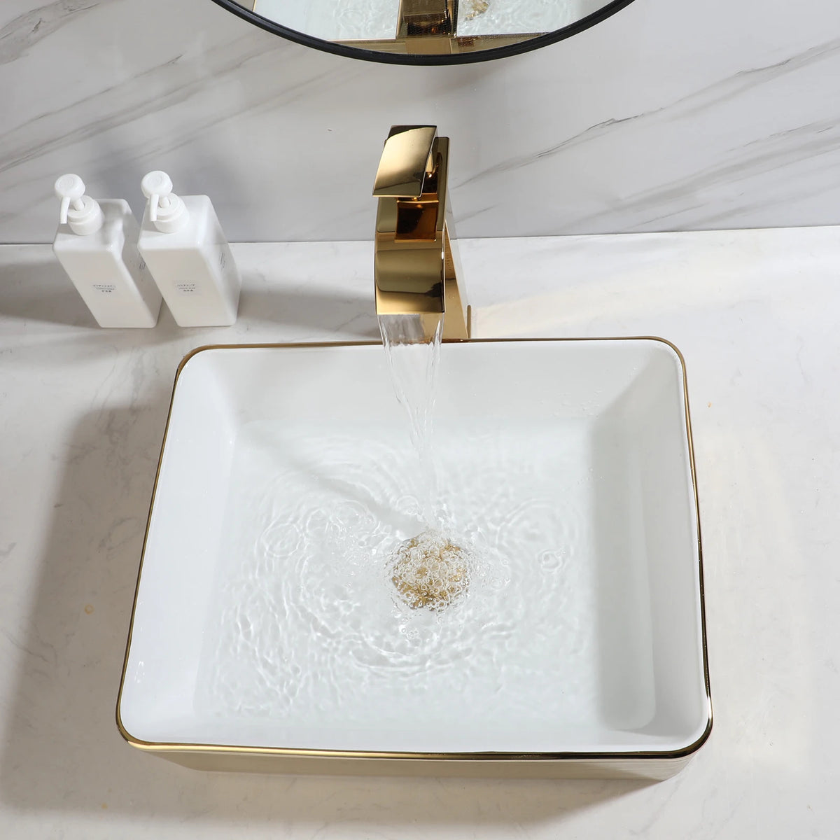 White square ceramic vessel sink with gold stripes, top view with gold faucet