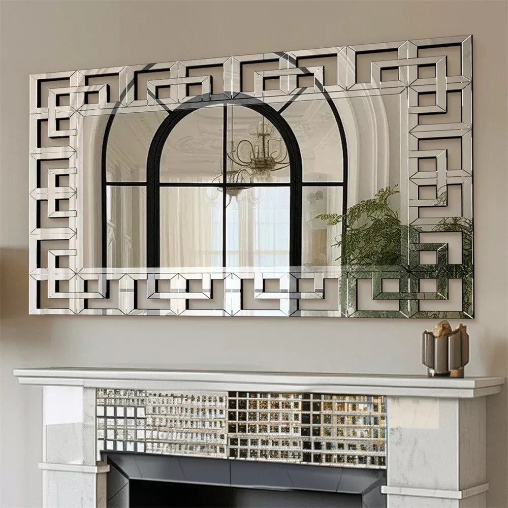 Front view of the Greek-key Venetian mirror's mirrored fretwork border above a mantel