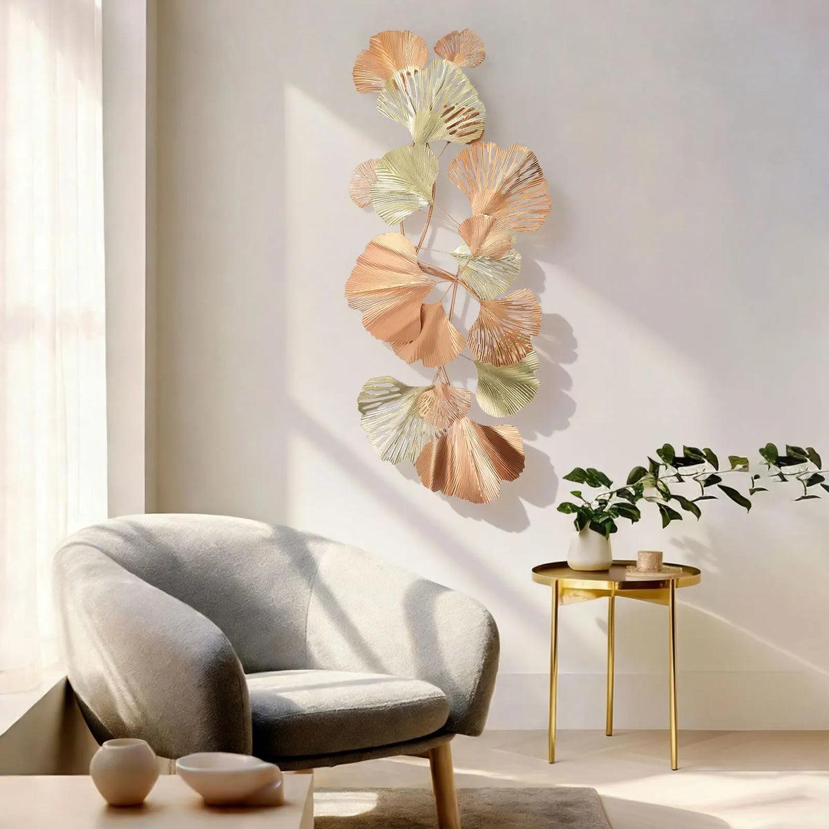 Vertical ginkgo leaf wall art beside a grey armchair