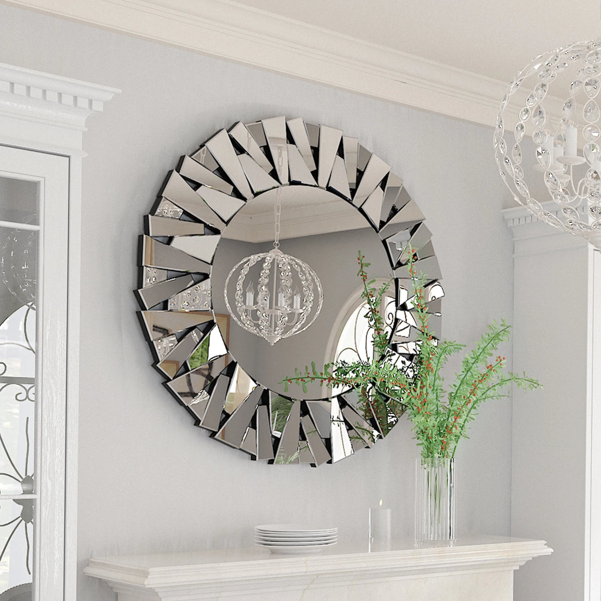 Silver sunburst mirror with mirrored shard frame reflecting a crystal pendant