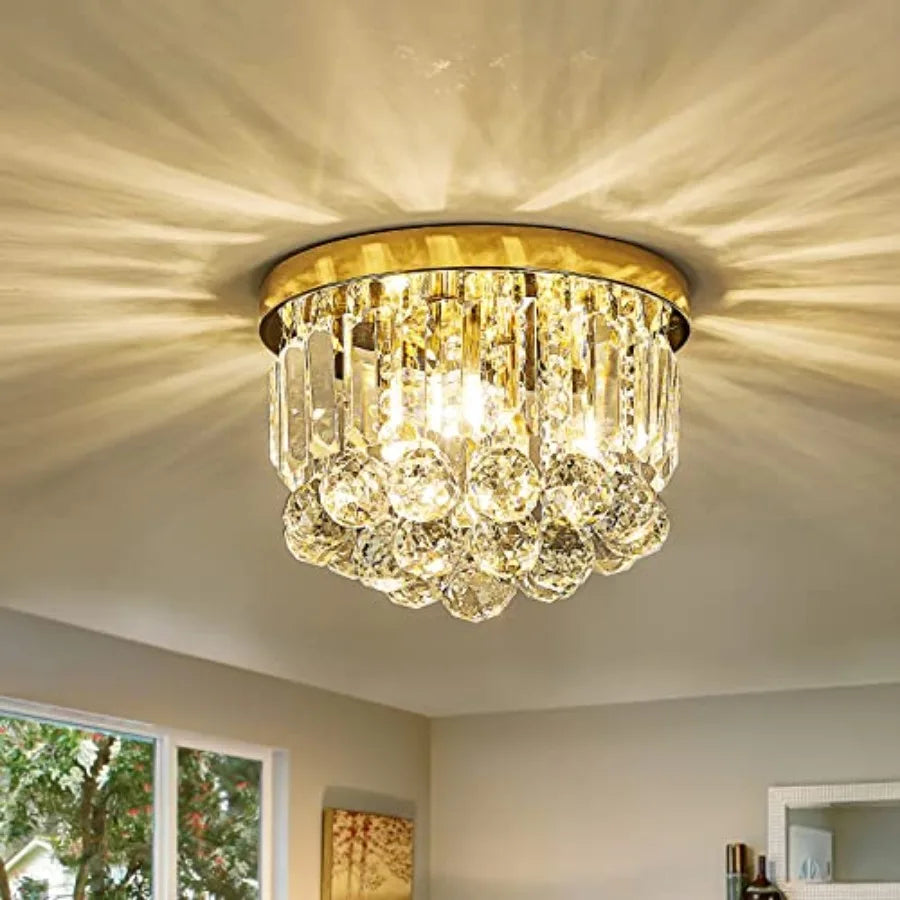 Small gold flush mount ceiling light with tiers of crystal drops, lit