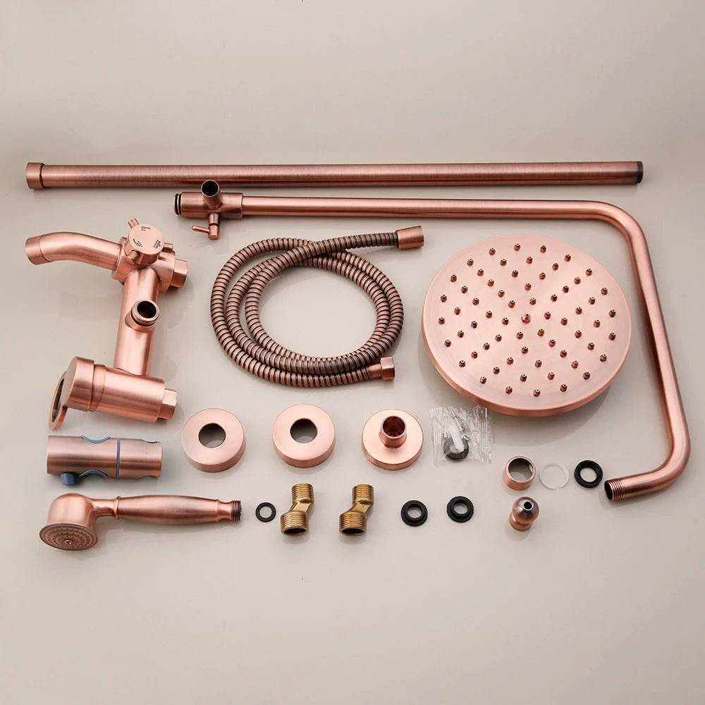 Antique copper rainfall shower set laid out: round rain head, riser, hand shower and fittings