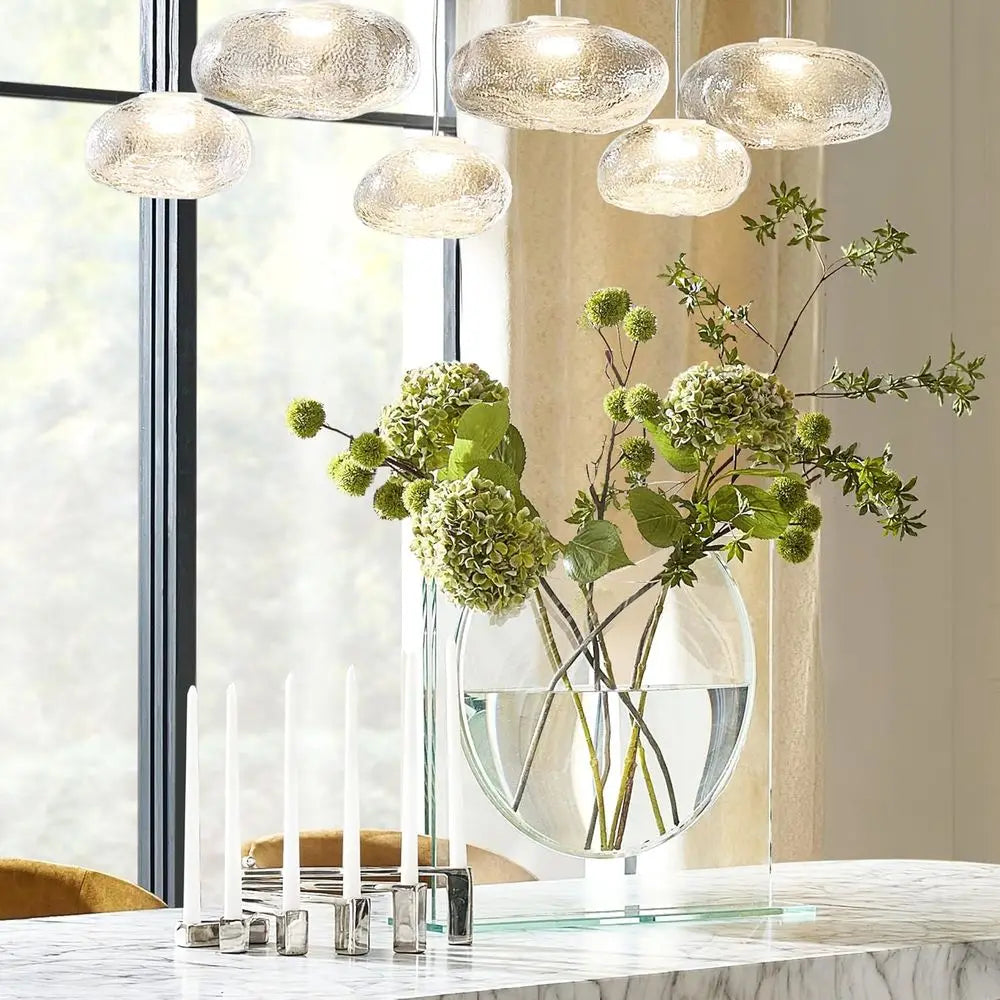 Clear glass ellipse vase on a marble dining table