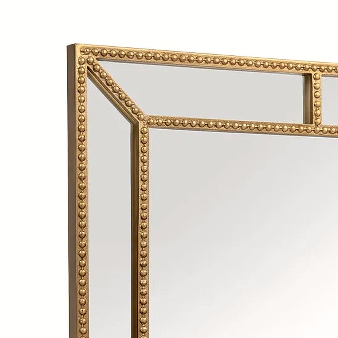 Close-up of the continuous gold beading along the upper corner of the rectangular mirror frame