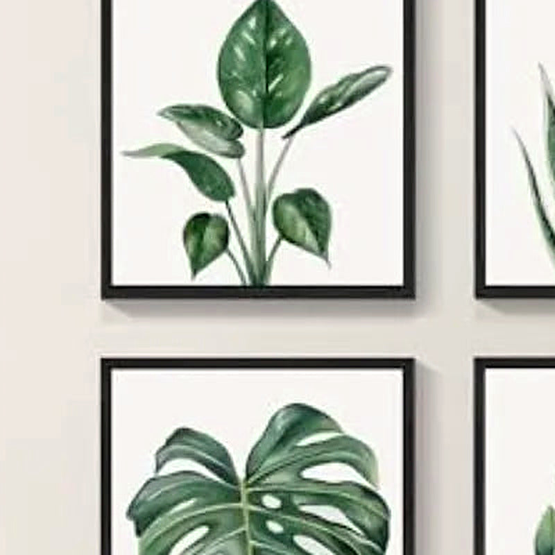 Close-up of the broad-leaf botanical print in a slim black frame