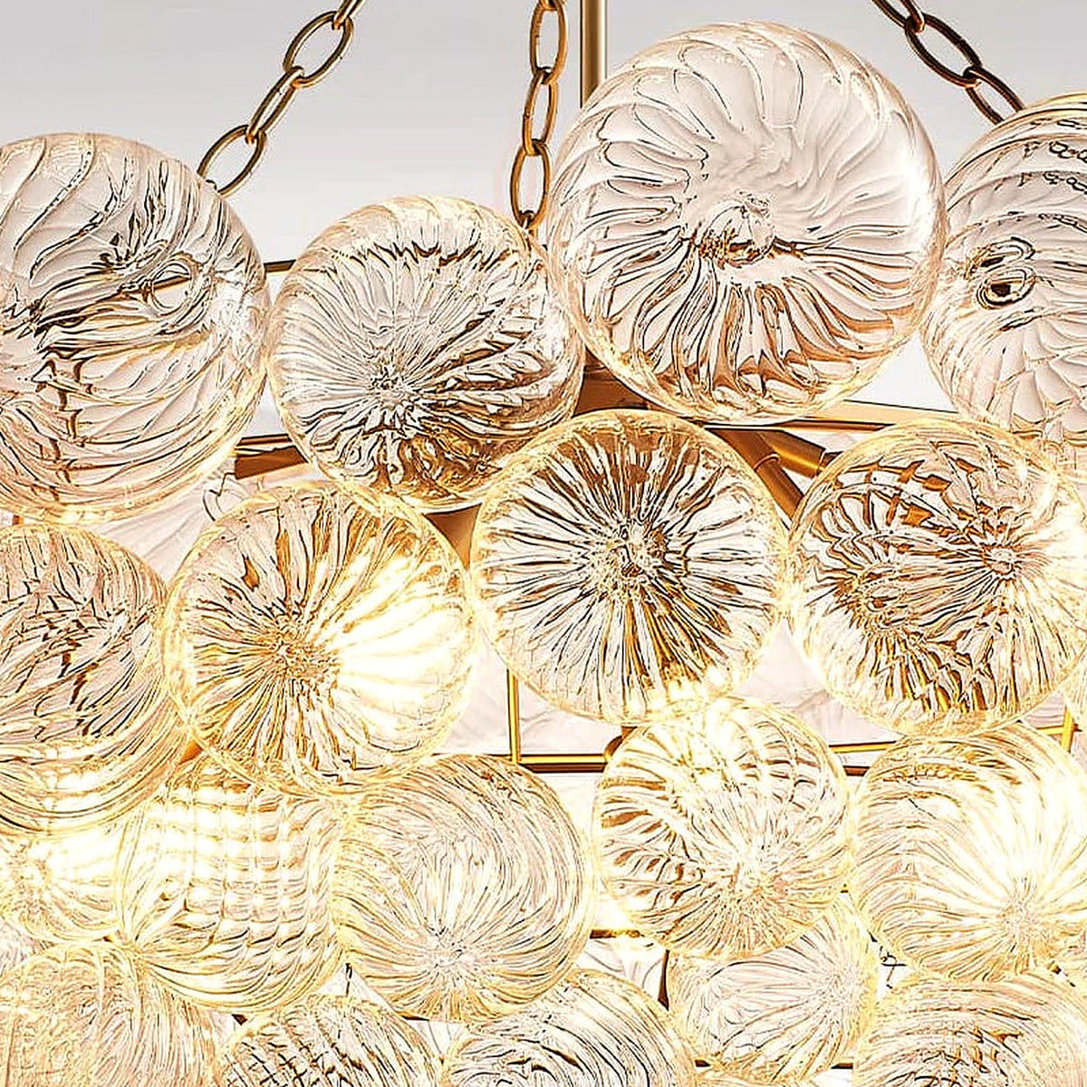 Close-up of ribbed, spiraled glass globes catching warm light on the bubble cluster chandelier