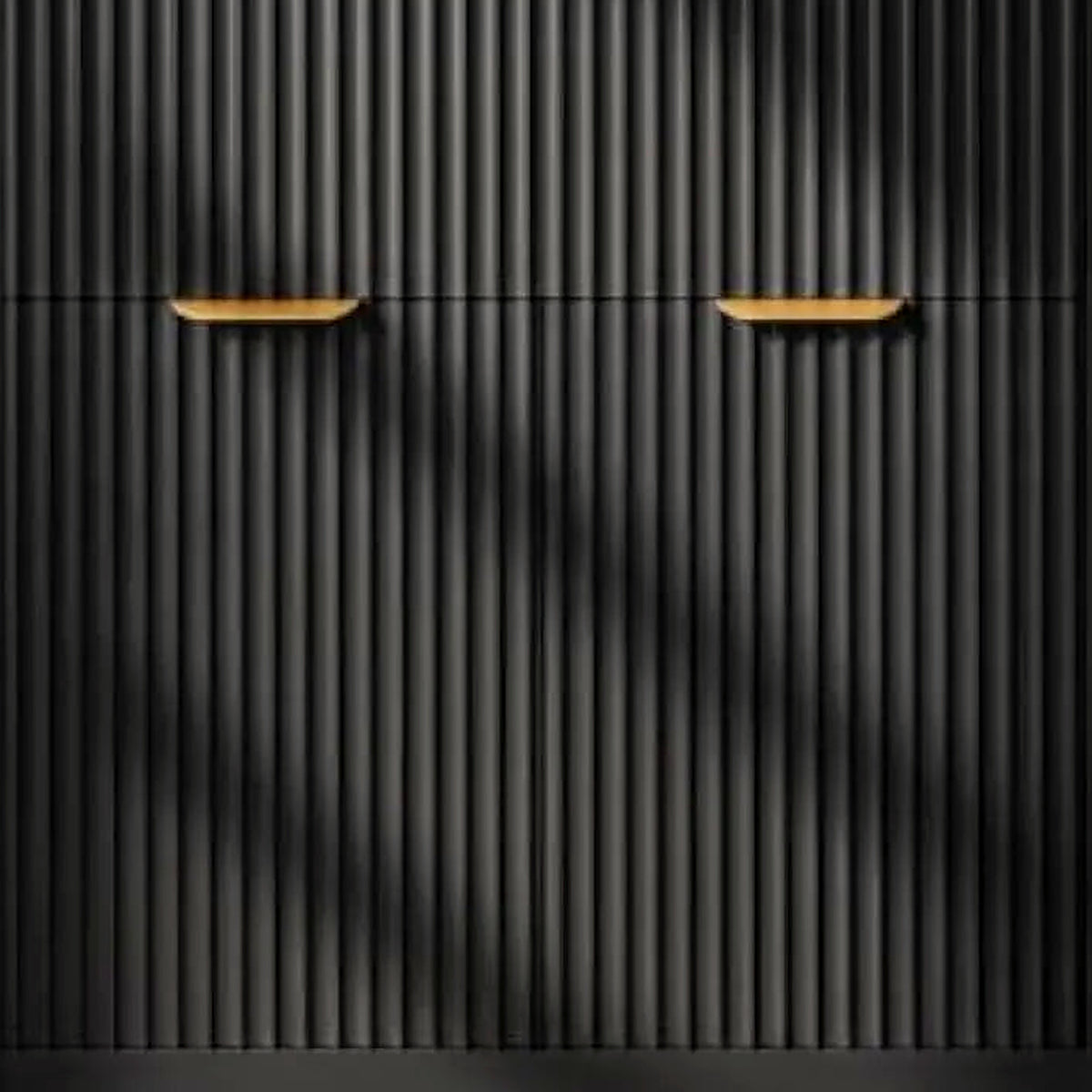 Close-up of the vertical fluting and brushed gold bar pull on the black vanity