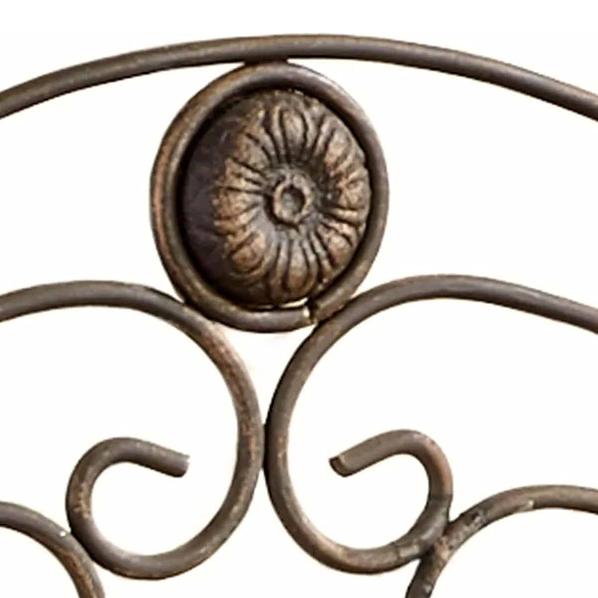 Detail of the fluted floral medallion in antique bronze with gold highlights crowning the bath shelf