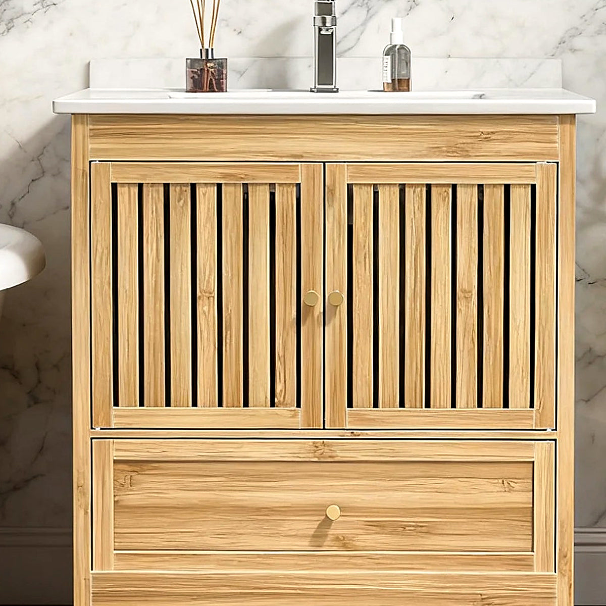 Close-up of the vertical bamboo fluting and gold knobs on the vanity doors