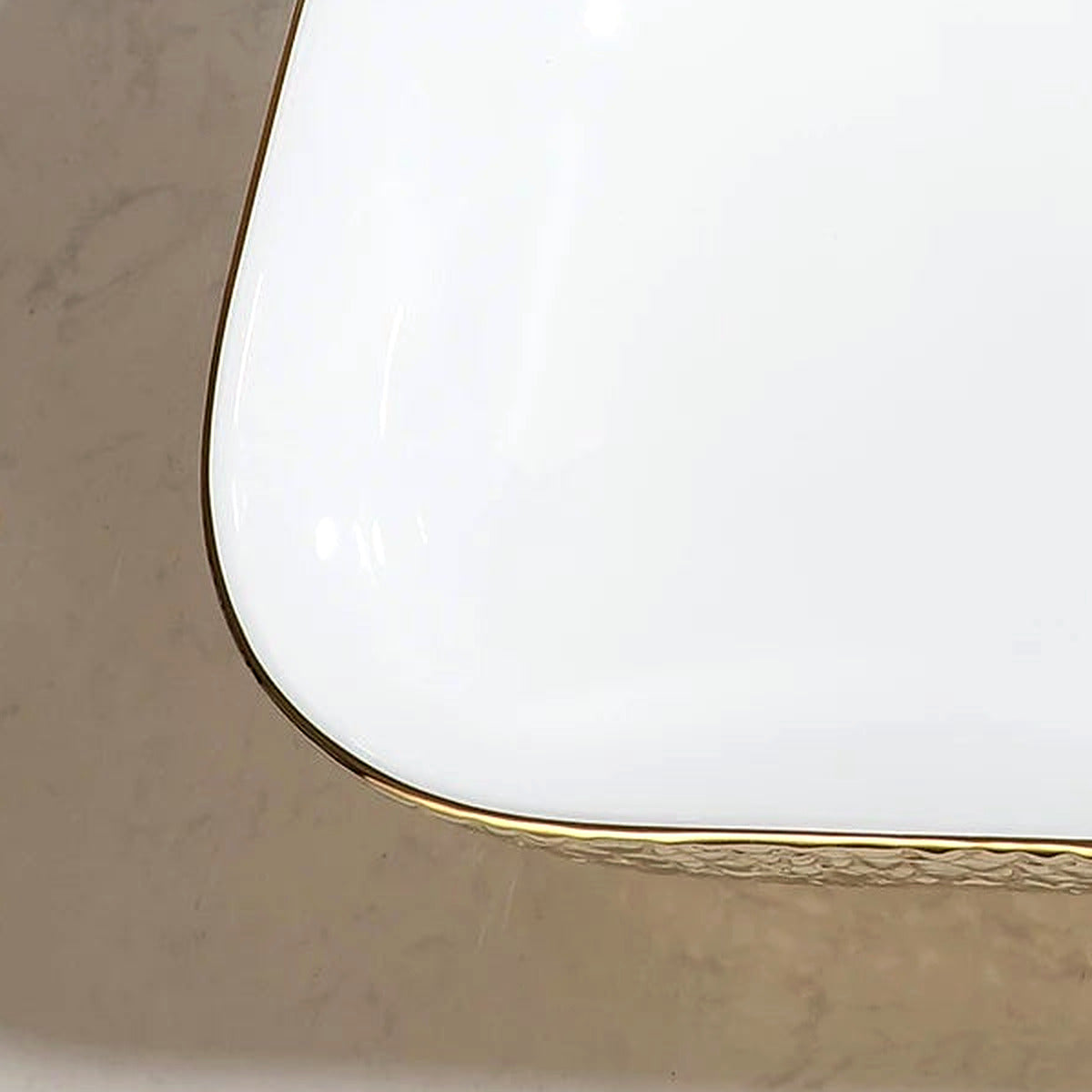 Close-up of the hammered gold exterior texture on the ceramic vessel sink