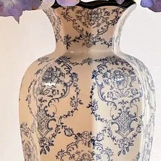 Close-up of the paneled porcelain body with hand-painted blue damask scrollwork