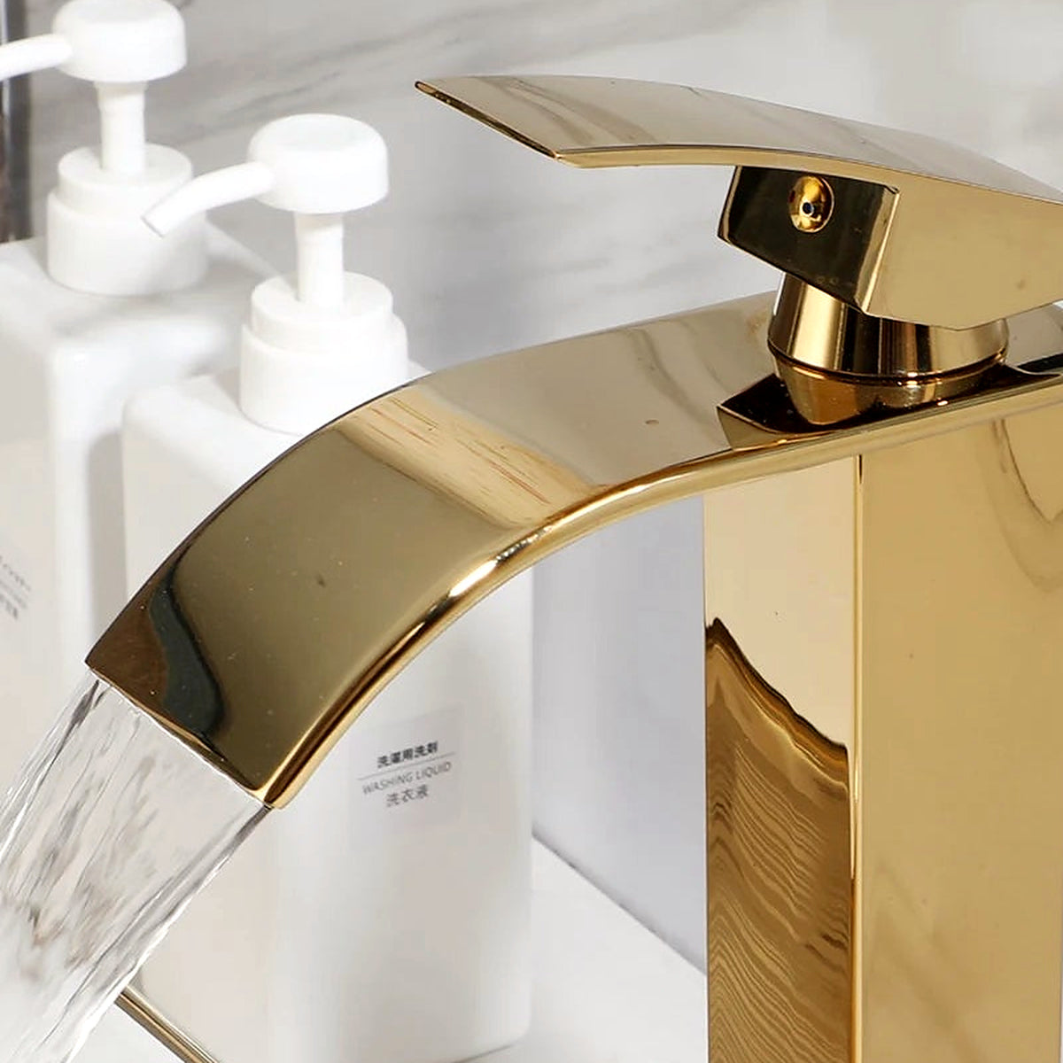 Detail of the polished gold waterfall faucet included with the sink set