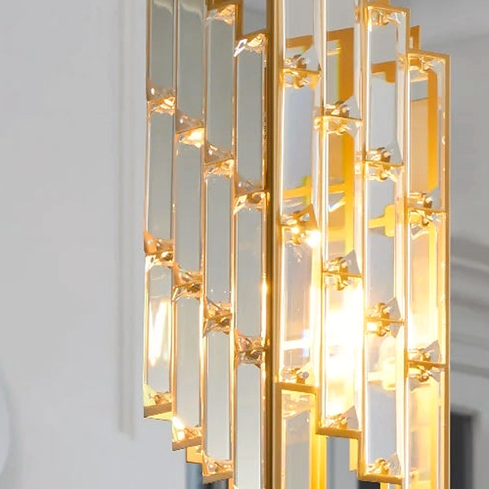Detail of the faceted crystal prisms and gold hardware on a single pendant light