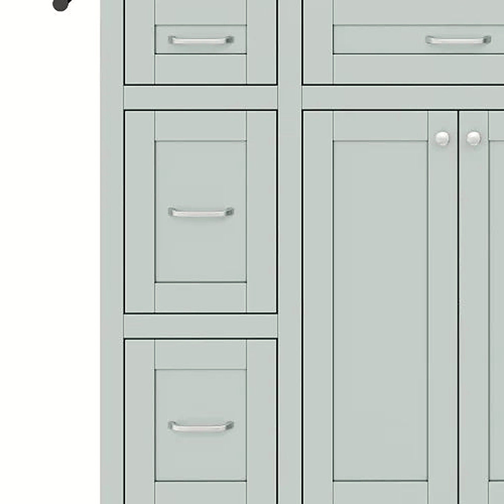 Detail of the stacked side drawers and silver bar pulls in mint green