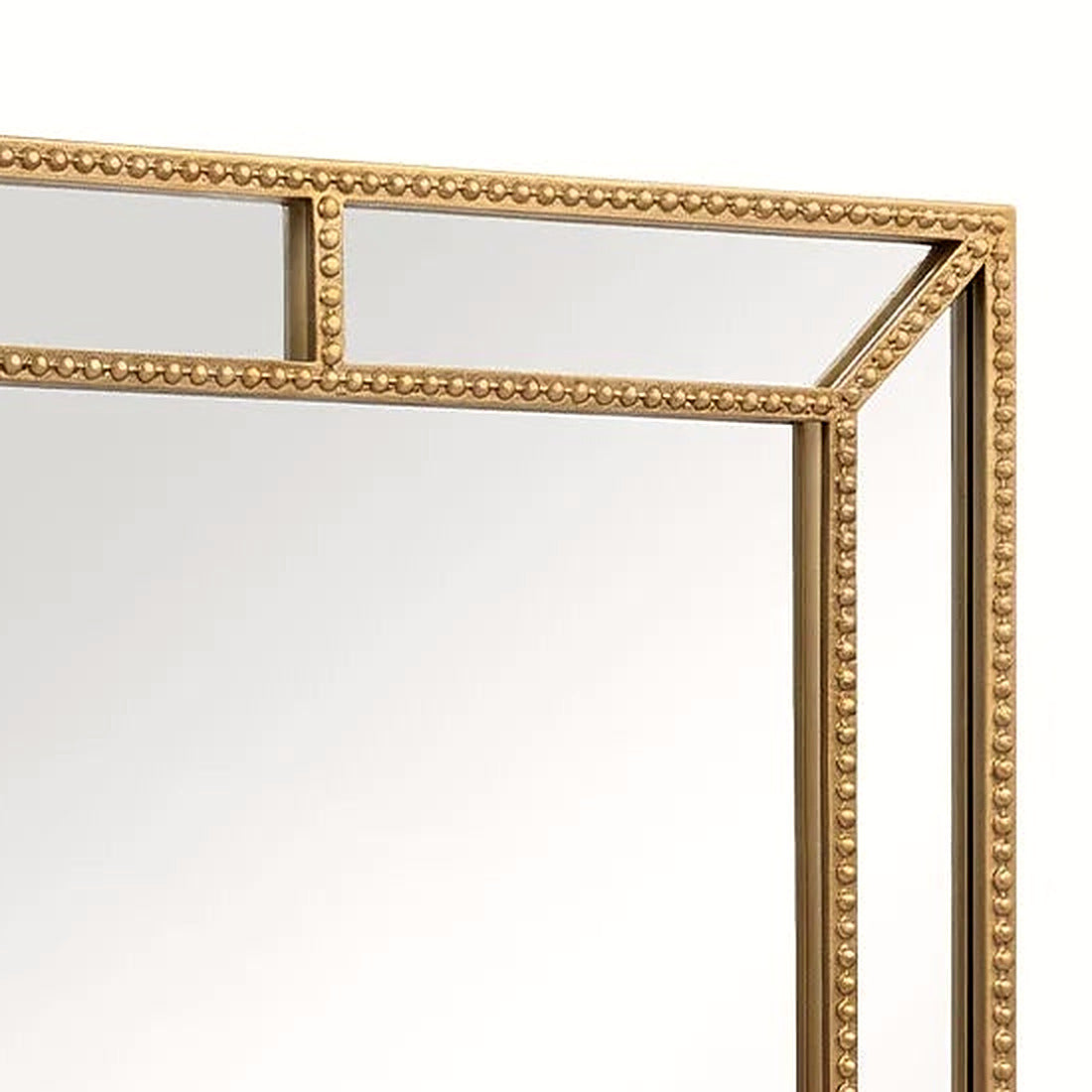 Detail of the beaded gold top-right corner and mirrored border panels on the wall mirror