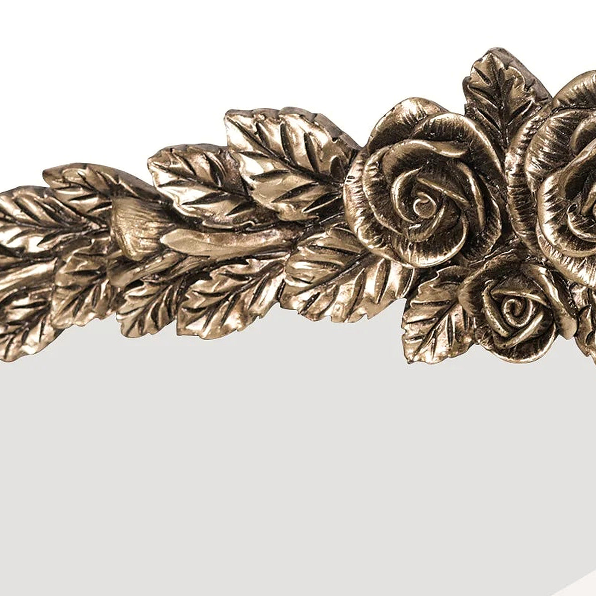 Detail of layered brass leaves and rosebuds along the left side of the baroque crest