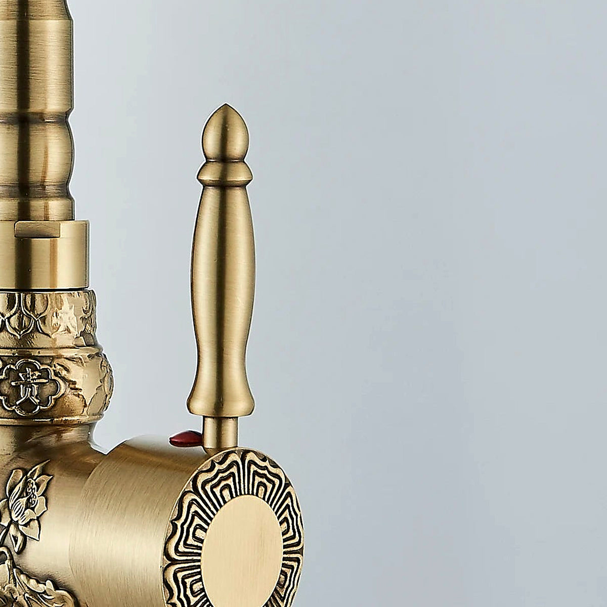 Detail of the single lever handle and sunburst hub in brushed antique brass