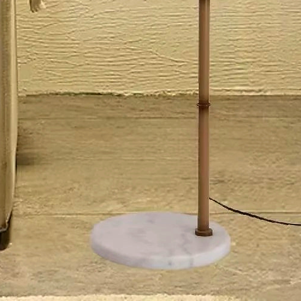 Close-up of the circular white marble base with soft grey veining