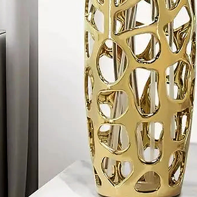 Detail of the sculpted gold lattice and lustrous mirror-like finish at the vase's base