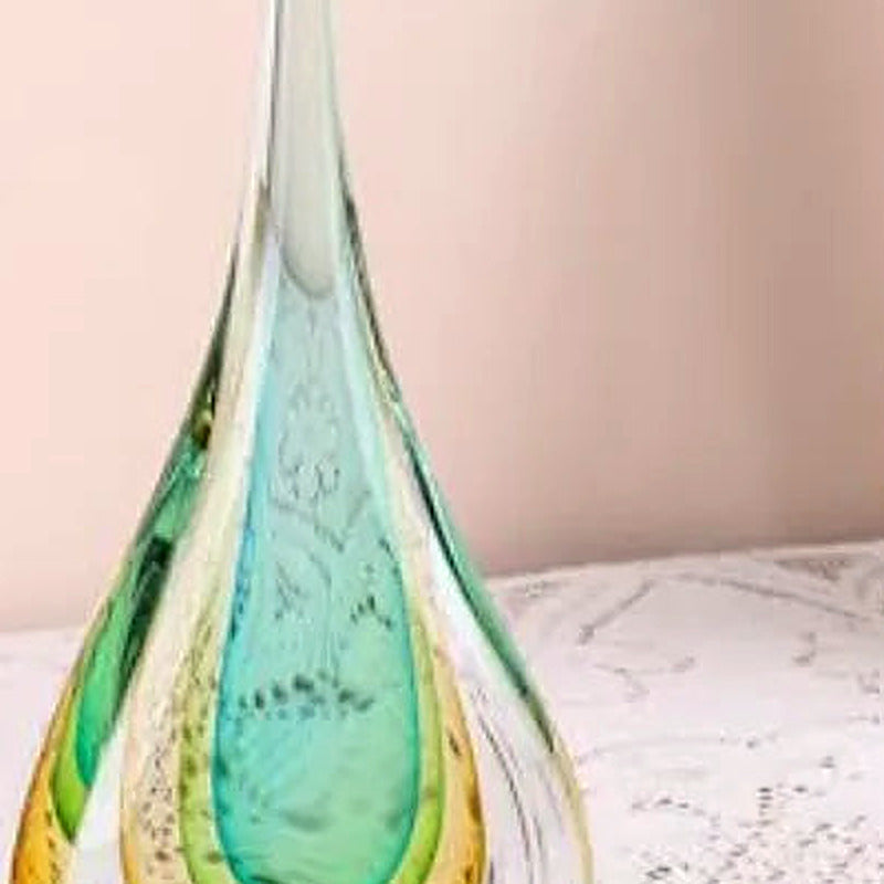 Close-up of the elongated clear glass tip of the teardrop sculpture