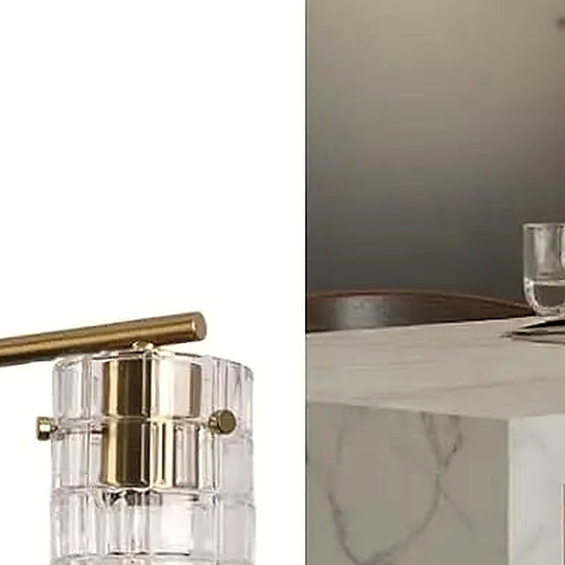 Close-up of a cylindrical clear glass shade and brass socket