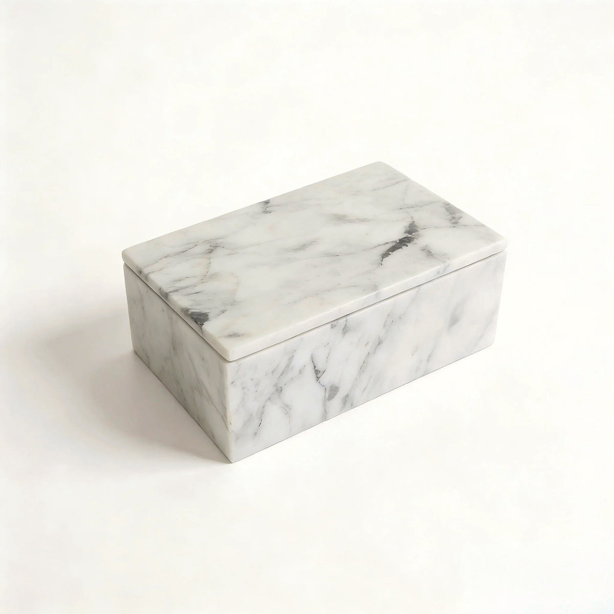 Carrara white marble lidded vanity box with soft grey veining on a clean white backdrop
