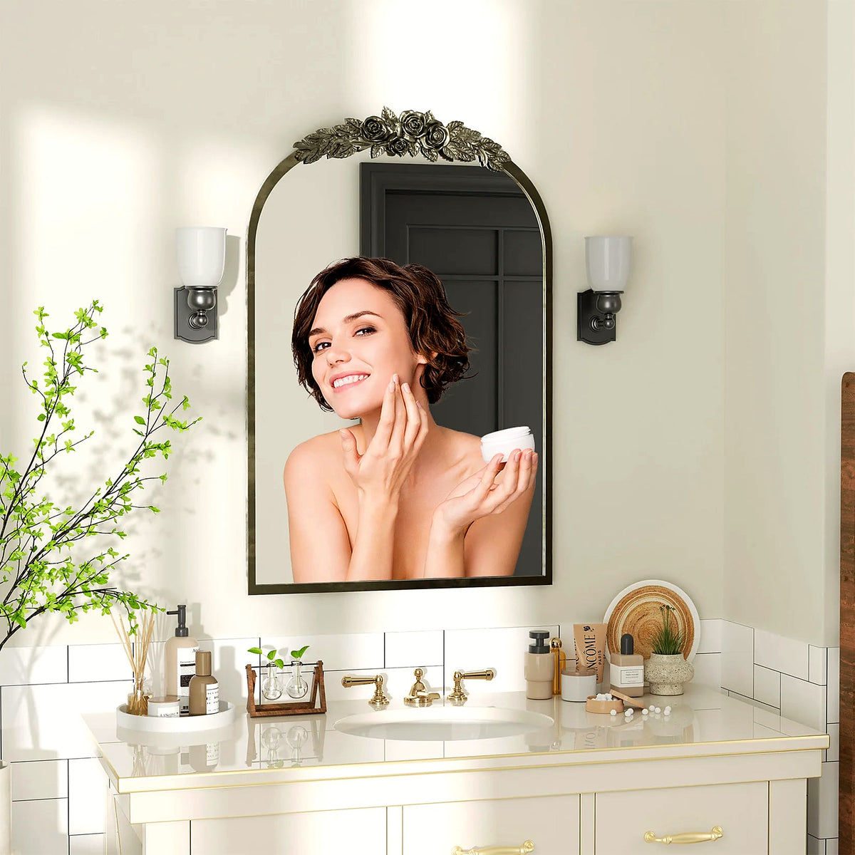 Antique brass baroque arched mantel mirror above a white bathroom vanity (faucet, sconces and décor shown for styling)