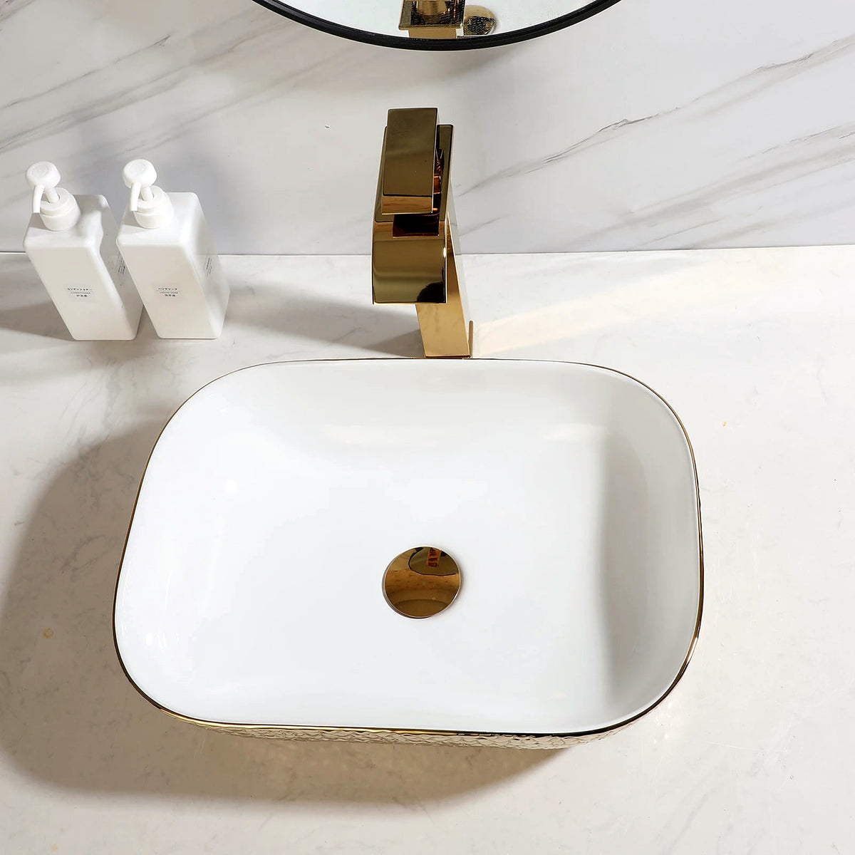 Gold hammered ceramic vessel sink with white basin, gold trim and matching gold waterfall faucet