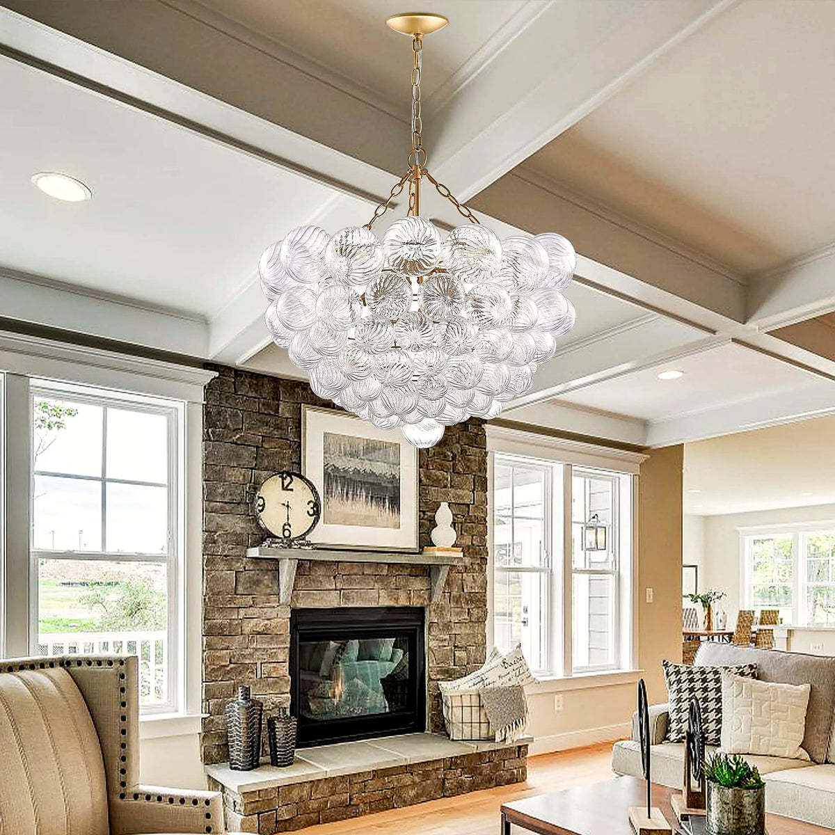 Ribbed glass bubble cluster chandelier suspended in a living room with a stone fireplace