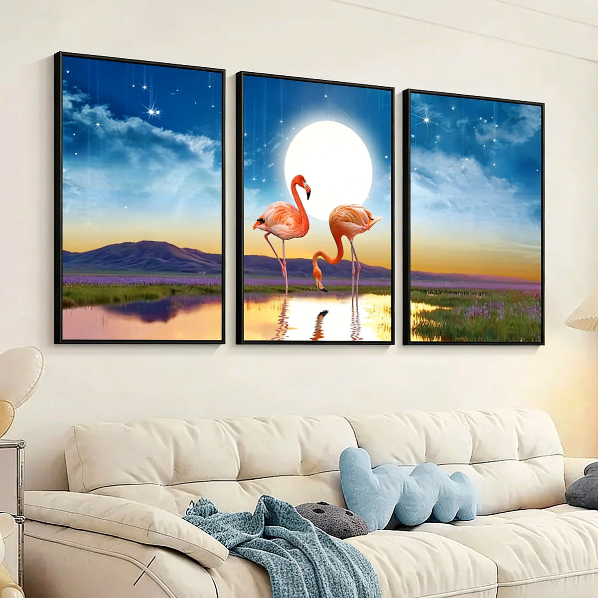 Three flamingo seascape prints in slim black frames above a cream sofa (sofa and pillows shown for styling)