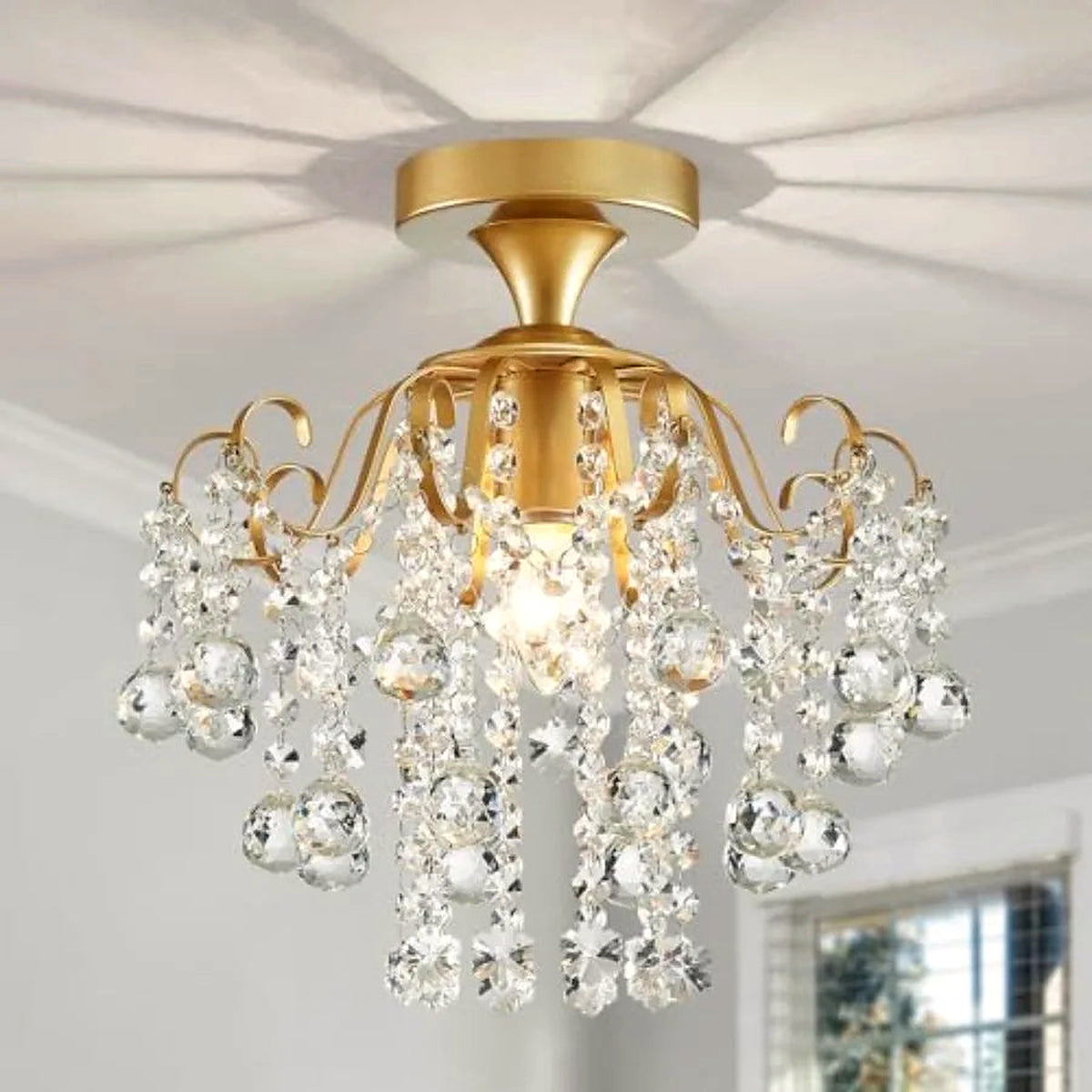 Gold crystal flush mount ceiling light casting a radial glow on the ceiling (room shown for styling)