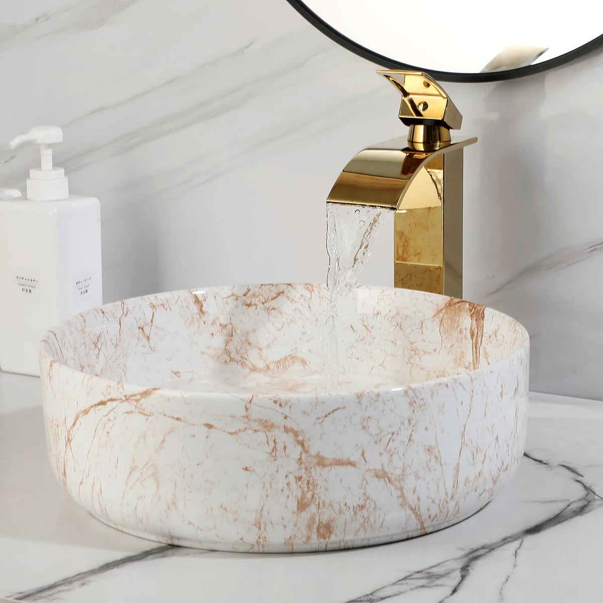 White marble-look ceramic vessel bowl with water flowing from the included polished gold faucet